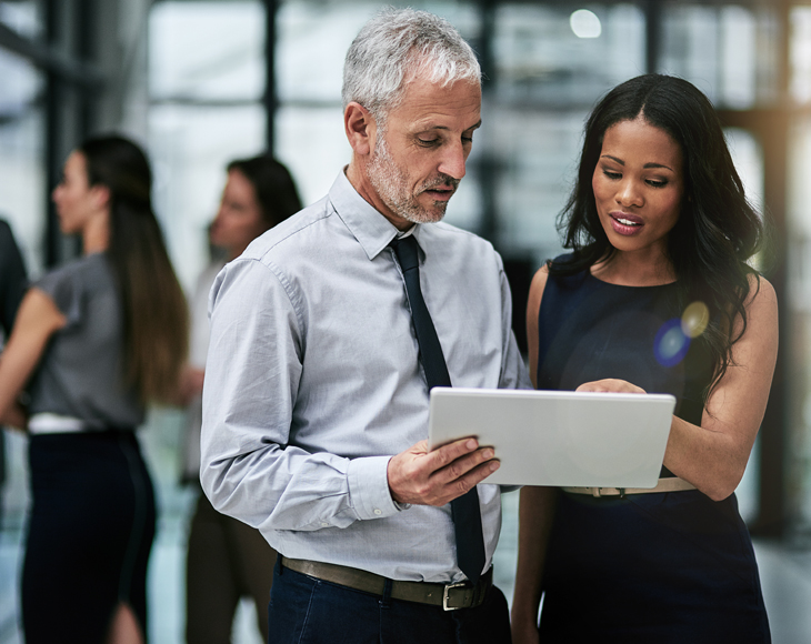 Colleagues review a workforce monitoring report