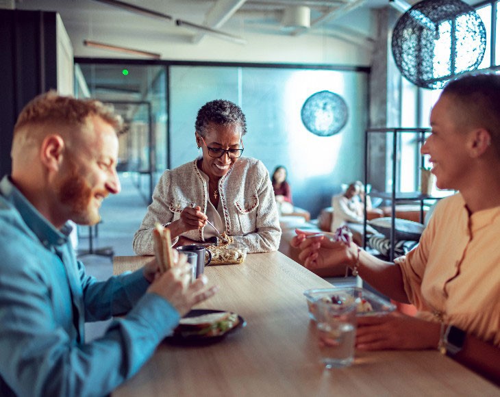 Employees discussing work over lunch